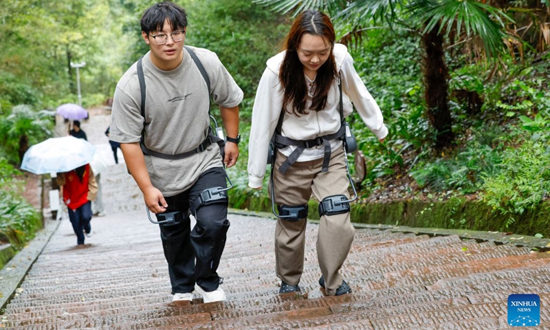 Tourists wearing exoskeleton robots hike in the Qiyun Mountain scenic area of Xiuning County, Huangshan City, east China's Anhui Province, Oct. 2, 2026.
The Qiyun Mountain scenic area offers exoskeleton robot rentals during the National Day holiday to help visitors hike with less effort.
The lightweight, easy-to-use devices sense body movements, providing uphill assistance and downhill cushioning to protect knees and reduce leg strain.
With a growing number of hikers in recent years, the area now offers over 20 such robots, using technology to deliver a smarter mountain climbing experience. Photo: Xinhua