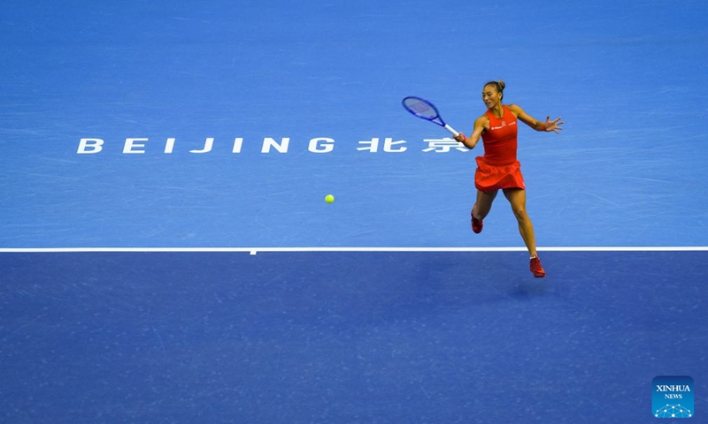 Zheng Qinwen of China hits a return during the women's singles round of 32 match against Marie Bouzkova of the Czech Republic at 2026 China Open tennis tournament in Beijing, China, Oct. 5, 2026. (Xinhua/Sun Fei)