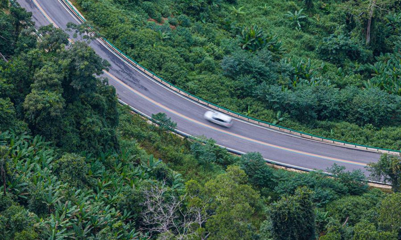An aerial drone photo taken on Aug. 22, 2026 shows a view of the Ledong section of a scenic ring road surrounding the Hainan Tropical Rainforest National Park in south China's Hainan Province. (Xinhua/Pu Xiaoxu)