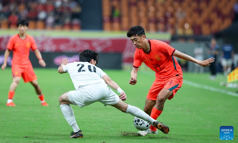 Alijon Karomatullozoda (L) of Tajikistan vies with Liu Yang of China during the CFA Team China International Football Competitions Chongqing 2026 between China and Tajikistan in Chongqing, Oct. 6, 2026. Photo: Xinhua