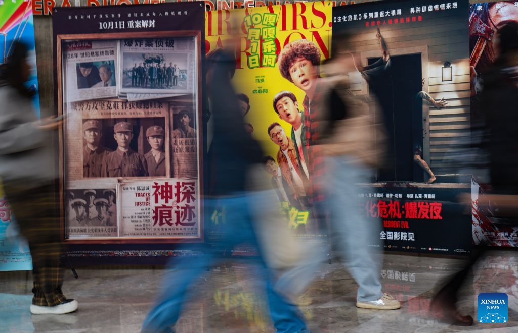 Spectators walk past posters at a cinema in Kunming City, southwest China's Yunnan Province, Oct. 6, 2026. During the National Day holiday, people go to cinemas to watch movies across China. (Photo by Zheng Yi/Xinhua)