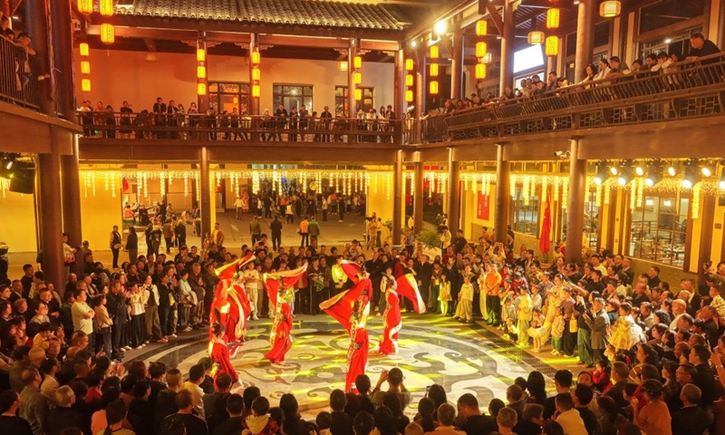 A drone photo taken on Oct. 5, 2026 shows people watching a performance at a scenic spot in Zigui County, central China's Hubei Province. During the National Day holiday, night tours were launched across China to create diversified consumption scenes. Photo: Xinhua