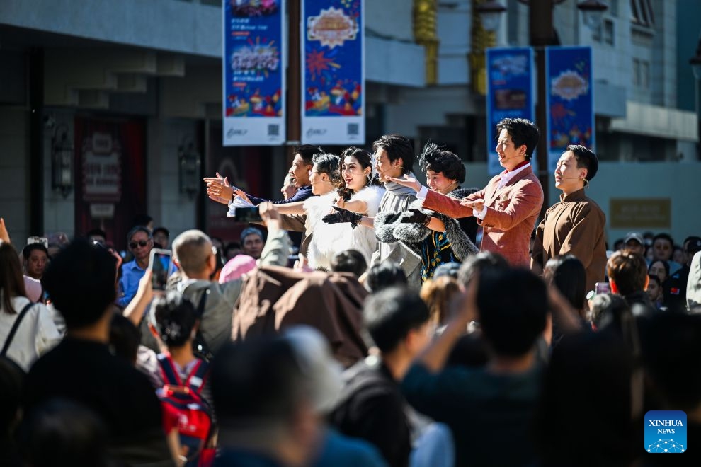 Performers greet the audience after their performance at a commercial street in north China's Tianjin, Oct. 6, 2026. During the National Day holiday, a special event of the 2026 Tianjin Theatre Festival unfolded across the city. Streets and alleys, century-old buildings and other cultural landmarks were transformed into open-air stages, presenting visitors with a feast of drama. (Xinhua/Zhao Zishuo)