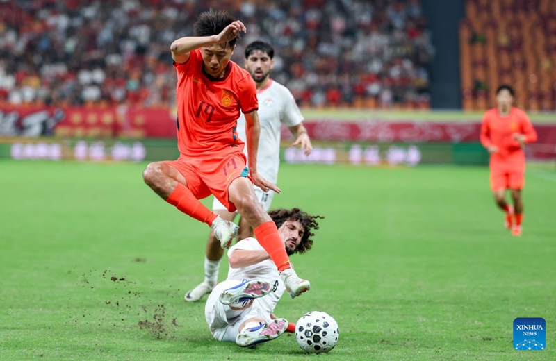 Liu Yang (top) of China vies with Vahdat Hanonov of Tajikistan during the CFA Team China International Football Competitions Chongqing 2026 between China and Tajikistan in Chongqing, Oct. 6, 2026. Photo: Xinhua