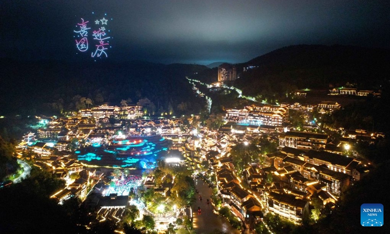 An aerial drone photo taken on Oct. 2, 2026 shows people watching a drone light show at Wujiangzhai scenic spot in Zunyi, southwest China's Guizhou Province. During the National Day holiday, night tours were launched across China to create diversified consumption scenes. Photo: Xinhua