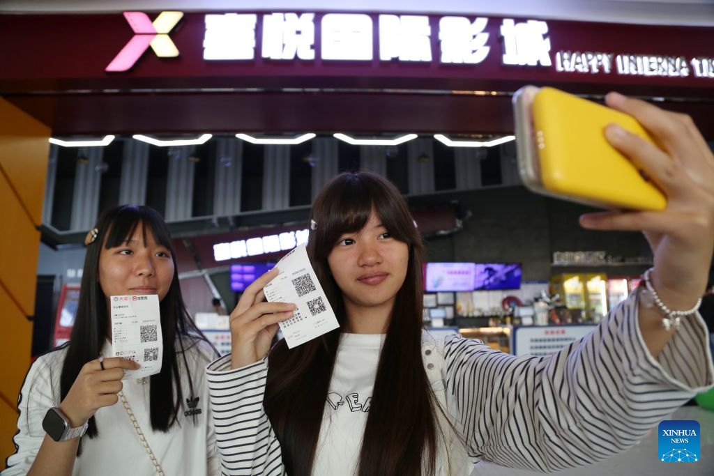 Spectators take a selfie at a cinema in Mengzi, southwest China's Yunnan Province, Oct. 5, 2026. During the National Day holiday, people go to cinemas to watch movies across China. (Photo by Xue Yingying/Xinhua)