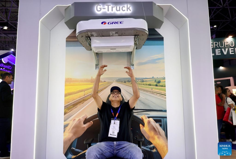 A visitor tries an air conditioner of Gree during the FEBRAVA Rio at the Riocentro convention and event center in Rio de Janeiro, Brazil, Oct. 6, 2026. The three-day FEBRAVA Rio (Portuguese short for International Fair of Refrigeration, Air Conditioning, Ventilation, Heating, Air and Water Treatment) kicked off here on Tuesday. Some Chinese brands showcased their latest products during the fair, drawing great attention from visitors. Photo: Xinhua