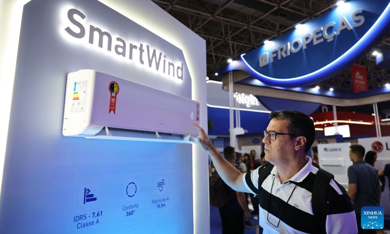 A visitor tries an air conditioner of Gree during the FEBRAVA Rio at the Riocentro convention and event center in Rio de Janeiro, Brazil, Oct. 6, 2026. The three-day FEBRAVA Rio (Portuguese short for International Fair of Refrigeration, Air Conditioning, Ventilation, Heating, Air and Water Treatment) kicked off here on Tuesday. Some Chinese brands showcased their latest products during the fair, drawing great attention from visitors. Photo: Xinhua