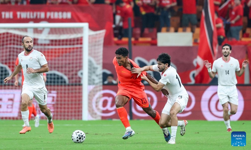 Shervoni Mabatshoev (R) of Tajikistan vies with Huang Shenghao of China during the CFA Team China International Football Competitions Chongqing 2026 between China and Tajikistan in Chongqing, Oct. 6, 2026. Photo: Xinhua
