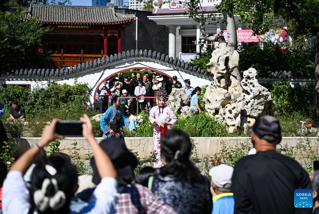 People watch a traditional opera at a park in north China's Tianjin, Oct. 6, 2026. During the National Day holiday, a special event of the 2026 Tianjin Theatre Festival unfolded across the city. Streets and alleys, century-old buildings and other cultural landmarks were transformed into open-air stages, presenting visitors with a feast of drama. (Xinhua/Zhao Zishuo)