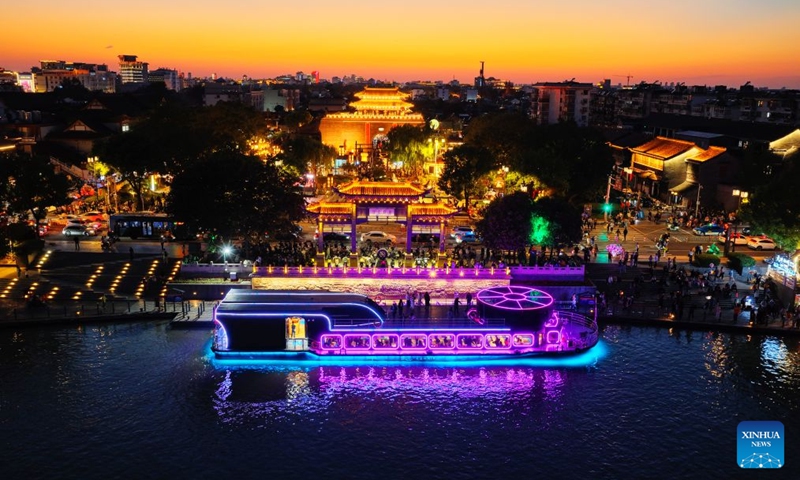A drone photo taken on Oct. 5, 2026 shows people cruising a scenic area in Yangzhou, east China's Jiangsu Province. During the National Day holiday, night tours were launched across China to create diversified consumption scenes. Photo: Xinhua