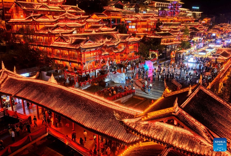A drone photo taken on Oct. 3, 2026 shows people visiting a commercial street in Xuan'en County in Enshi Tujia and Miao Autonomous Prefecture in central China's Hubei Province. During the National Day holiday, night tours were launched across China to create diversified consumption scenes. Photo: Xinhua