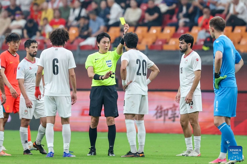 The referee (4th L) gives a yellow card to Alijon Karomatullozoda (3rd R) of Tajikistan during the CFA Team China International Football Competitions Chongqing 2026 between China and Tajikistan in Chongqing, Oct. 6, 2026. Photo: Xinhua