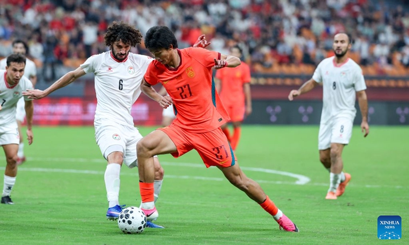 Zhao Songyuan (R) of China vies with Vahdat Hanonov of Tajikistan during the CFA Team China International Football Competitions Chongqing 2026 between China and Tajikistan in Chongqing, Oct. 6, 2026. Photo: Xinhua