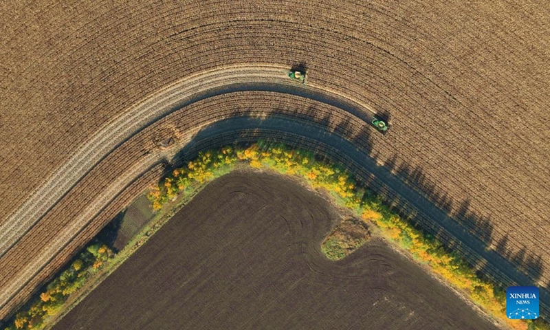 An aerial drone photo taken on Oct. 6, 2026 shows harvesters working in a corn field under Beidahuang Group in northeast China's Heilongjiang Province. China's top grain producer Heilongjiang Province has witnessed a bountiful harvest during the National Day holiday. Photo: Xinhua
