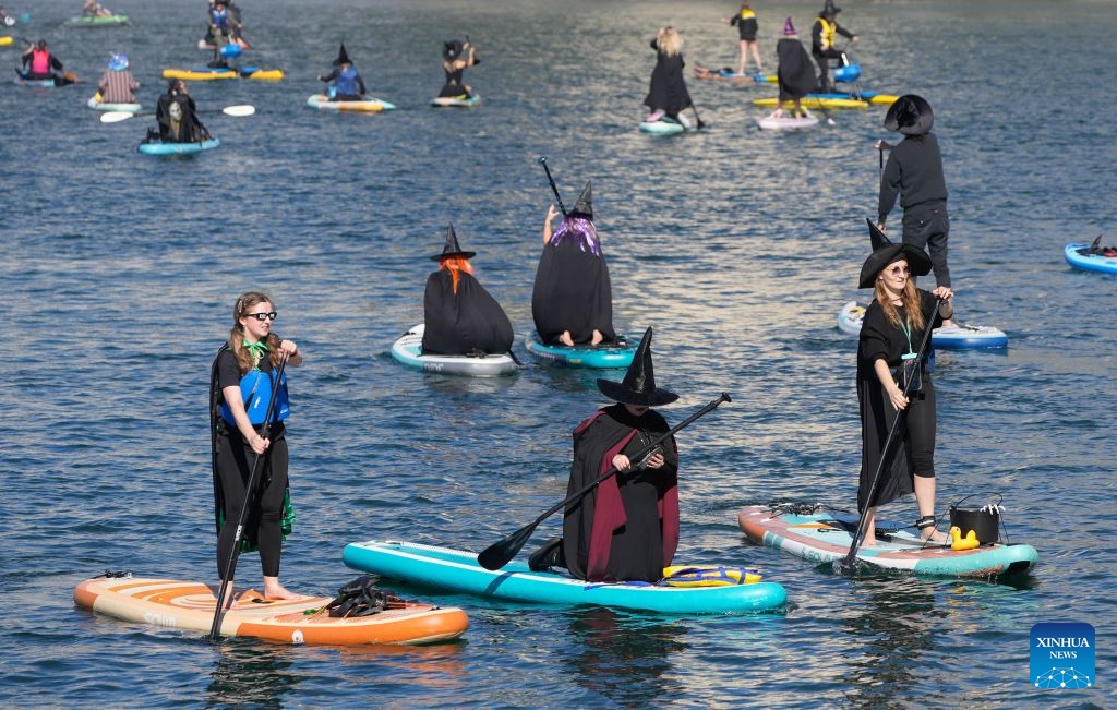 Participants dressed as witches paddle along the waterfront during the 6th Witchilano Paddle in Vancouver, British Columbia, Canada, Oct. 3, 2026. The annual event took place on Saturday, bringing together hundreds of costumed paddlers to celebrate the upcoming Halloween on the water. (Photo by Liang Sen/Xinhua)