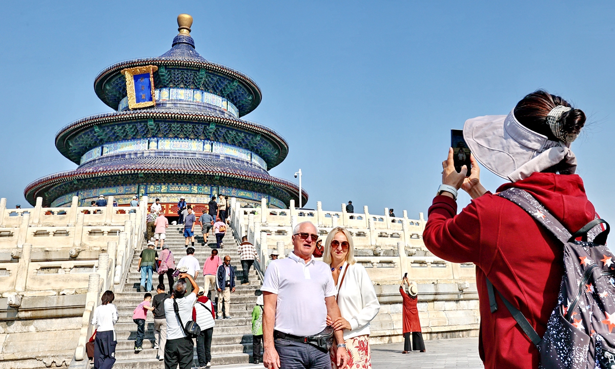 Tourists visit the Hall of Prayer for Good Harvests at the Temple of Heaven, where the landmark shines elegantly under autumn sunshine amid clear, refreshing weather marking the Cold Dew solar term, Beijing, October 8, 2026. Photo: IC