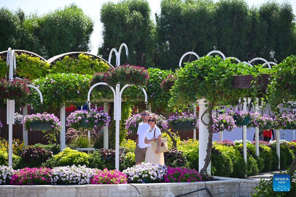 People visit Dubai Miracle Garden in Dubai, the United Arab Emirates, Oct. 8, 2026. Dubai Miracle Garden opened Thursday to the public for its 15th season. Featuring colorful floral displays and large-scale installations, the garden is a popular tourist attraction in Dubai. (Xinhua/Wang Zecong)