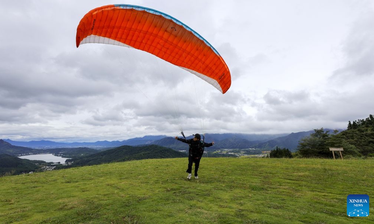 A staff member prepares for a flight at a flight camp in Hongcun Village of Yixian County, Huangshan City, east China's Anhui Province, Oct. 4, 2026. (Photo by Fan Chengzhu/Xinhua)