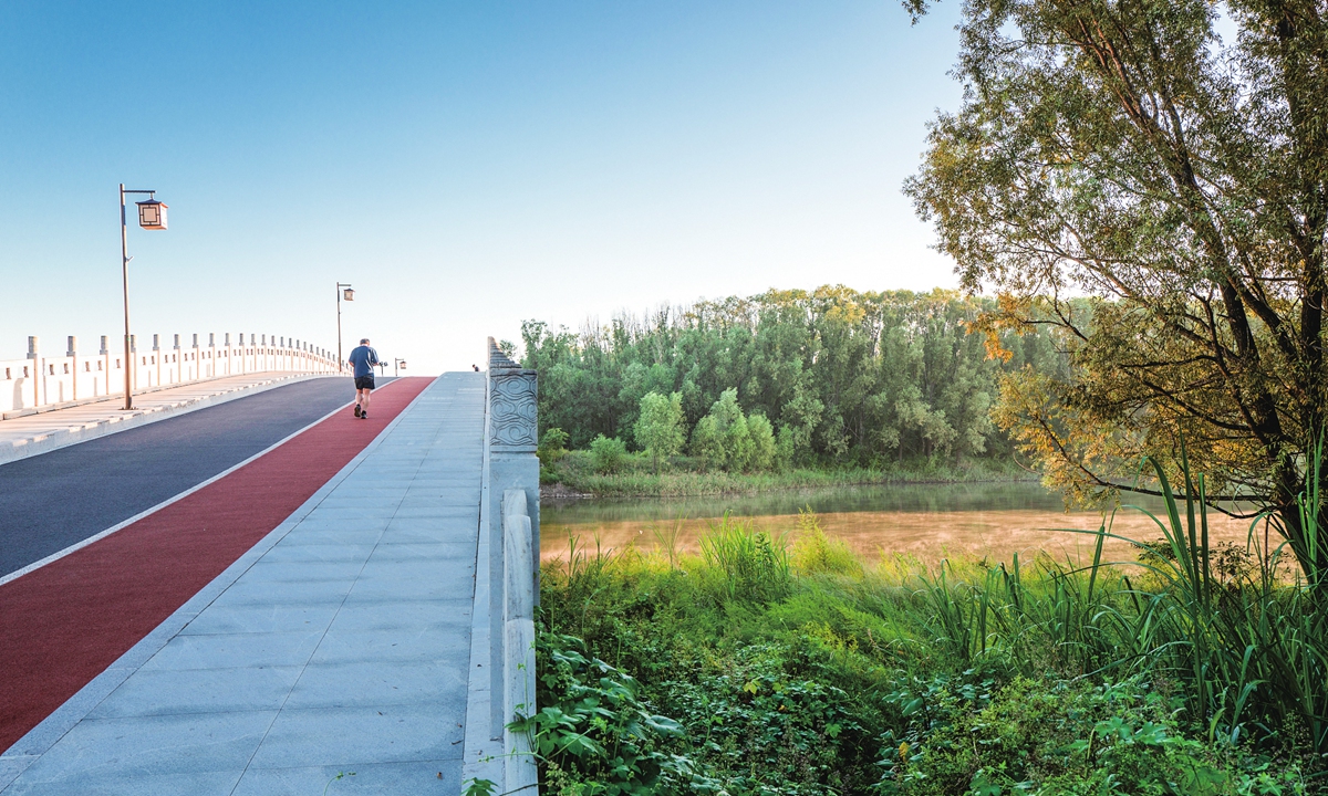 A man runs along a road in the Xiaohe National Wetland Park in Xiaoyi, North China's Shanxi Province, on August 30, 2026. Photos on this page: VCG 