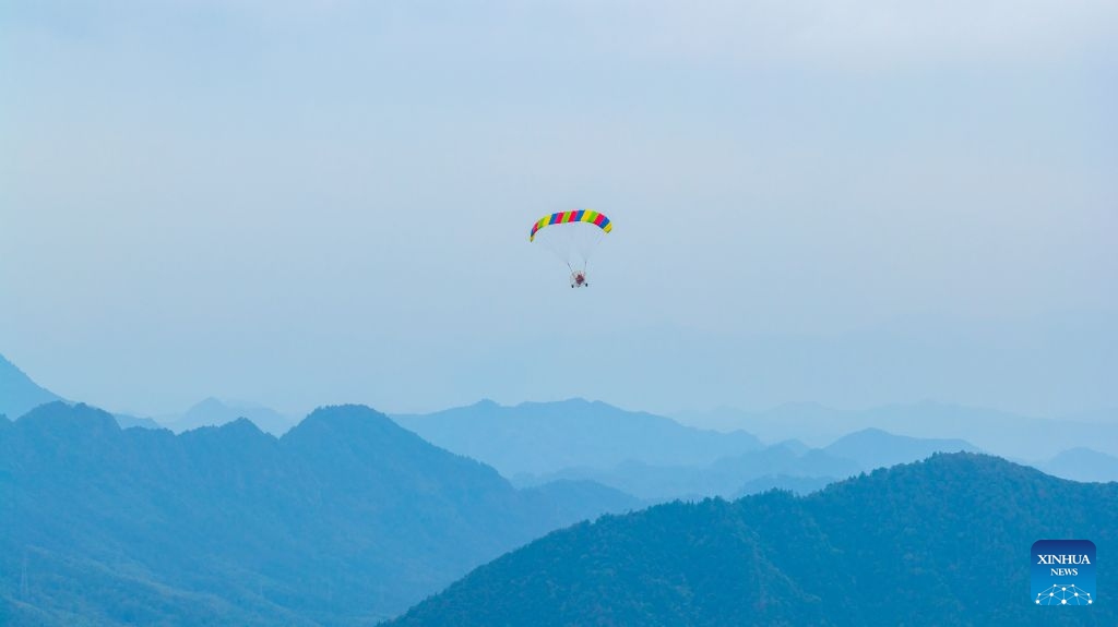 An aerial drone photo taken on Oct. 5, 2026 shows tourists enjoying powered paragliding in Hongcun Village of Yixian County, Huangshan City, east China's Anhui Province. (Photo by Fan Chengzhu/Xinhua)