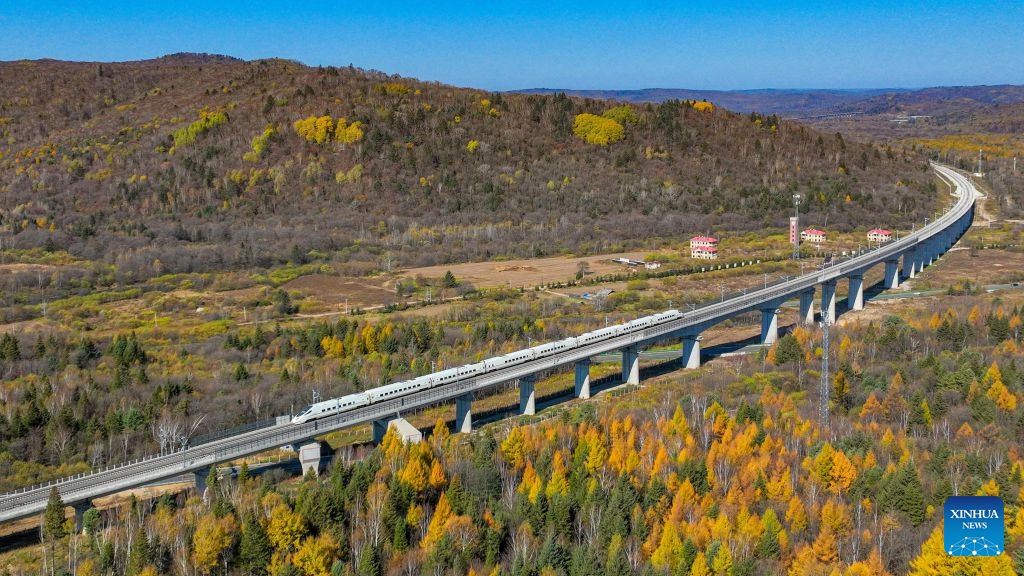 An aerial drone photo taken on Oct. 6, 2026 shows a bullet train of Harbin-Yichun high-speed railway running through forests in autumn scenery in Yichun, northeast China's Heilongjiang Province. The Harbin-Yichun high-speed railway, China's northernmost high-speed railway which officially entered service on Sept. 28, underlines the country's efforts to direct more transport infrastructure investment toward border areas, forest regions and less-developed regions, while helping boost development and prosperity in northeast China's border regions. (Photo by Yuan Yong/Xinhua)