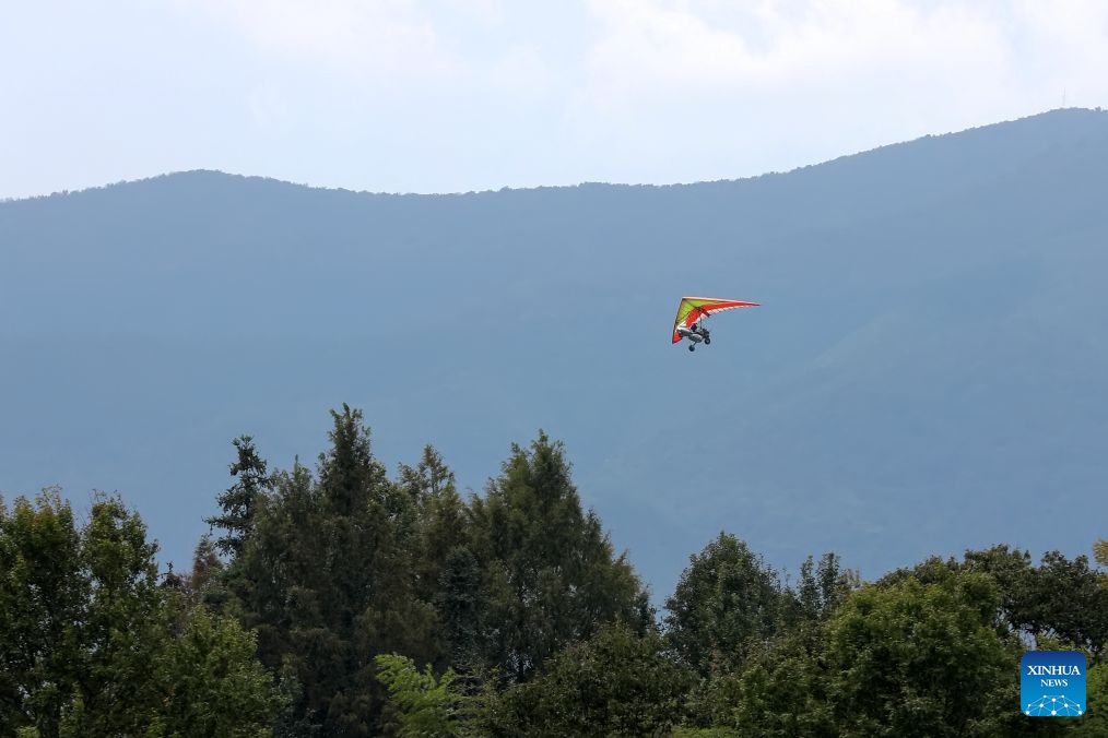 Tourists experience hang gliding in Hongcun Village of Yixian County, Huangshan City, east China's Anhui Province, Oct. 5, 2026. (Photo by Fan Chengzhu/Xinhua)