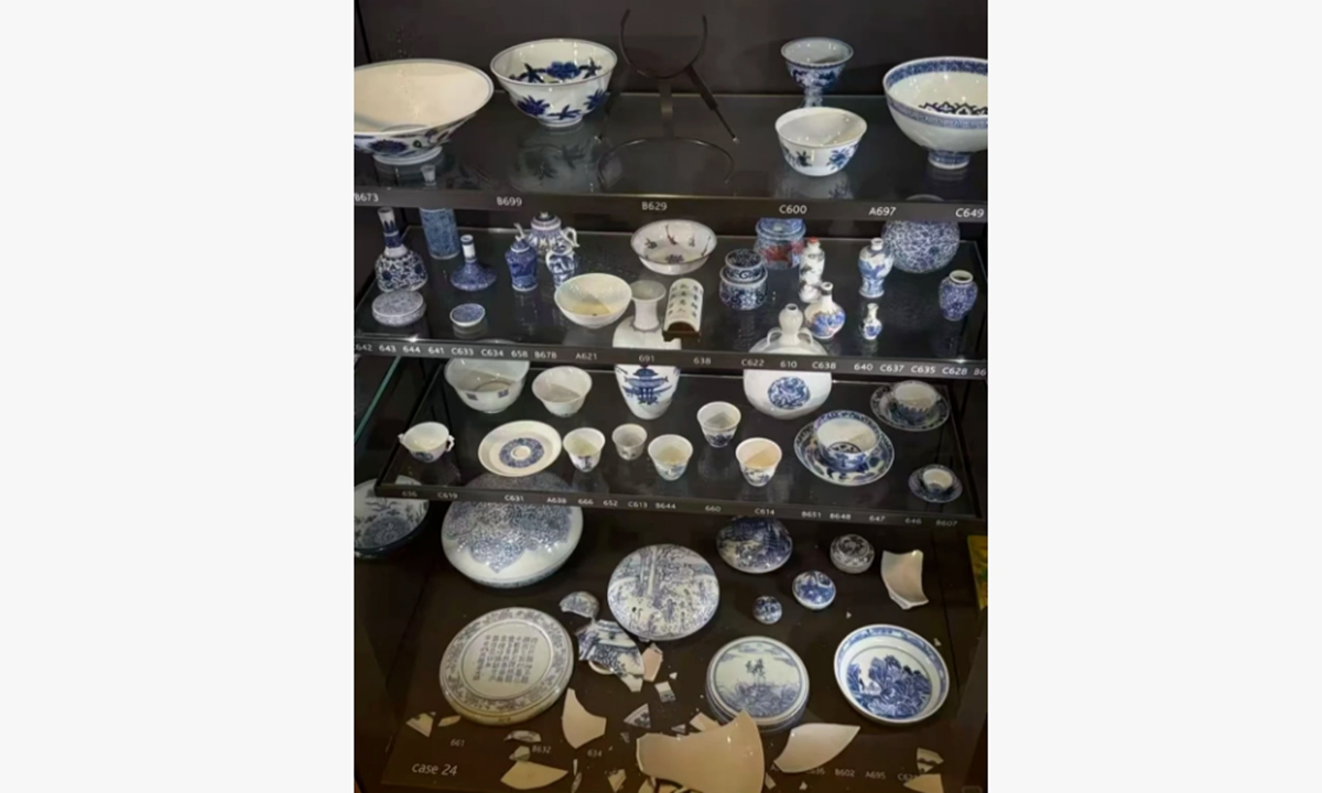 Broken porcelain fragments are seen scattered across the bottom of a display case in Room 95 of the British Museum, while the mounting position marked 