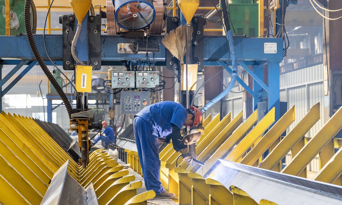 Workers grind structural components at a steel production plant in Hefei, East China's Anhui Province on October 9, 2026. In the first eight months, the value added of large industrial enterprises in the province increased by 12.7 percent year-on-year, according to data from the local statistics bureau. Photo: VCG