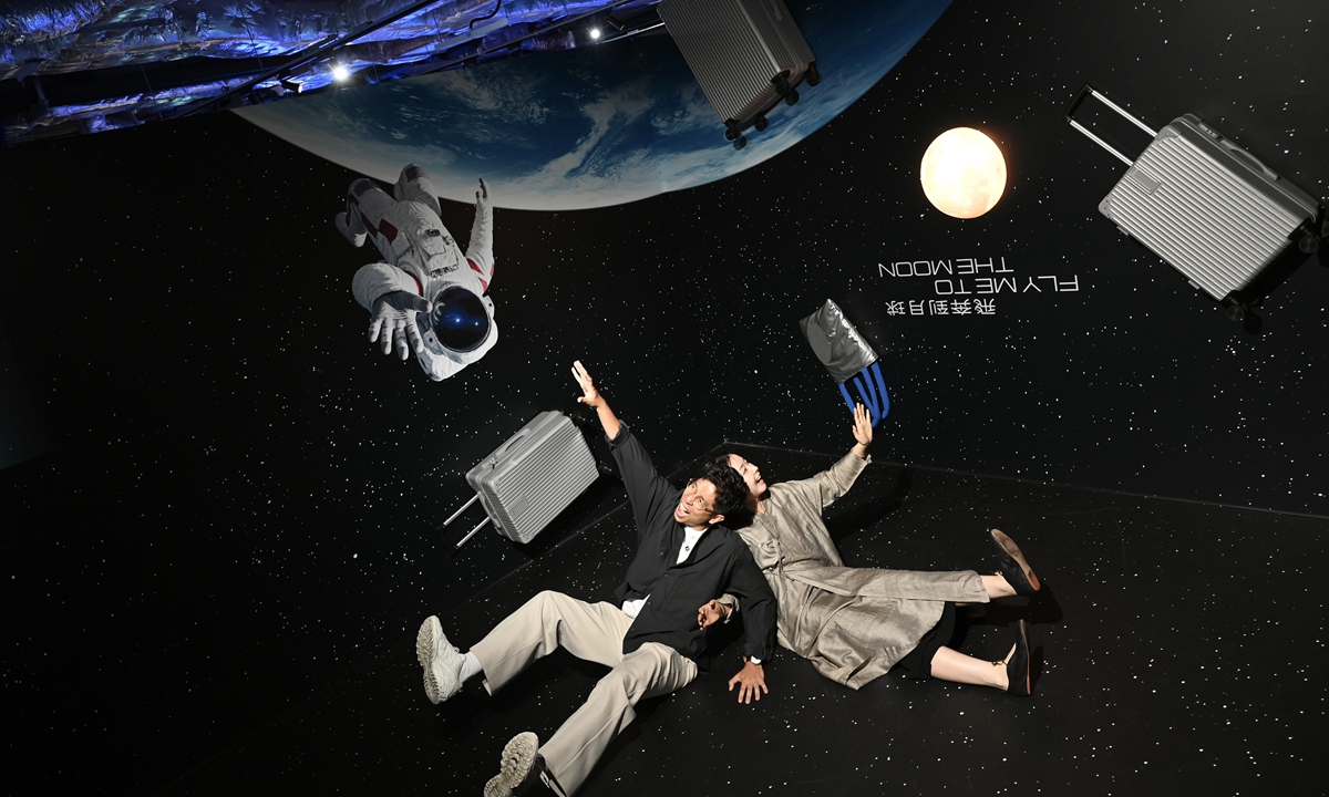 Visitors experience simulated space weightlessness at the immersive space exhibition 