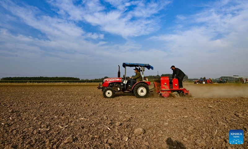 Farmers sow wheat with machinery in the fields at Huanglou Subdistrict in Qingzhou City, east China's Shandong Province, Oct. 10, 2026. As autumn sets in, farmers across China make the most of the farming season to work to ensure stable grain production. (Photo by Wang Jilin/Xinhua)