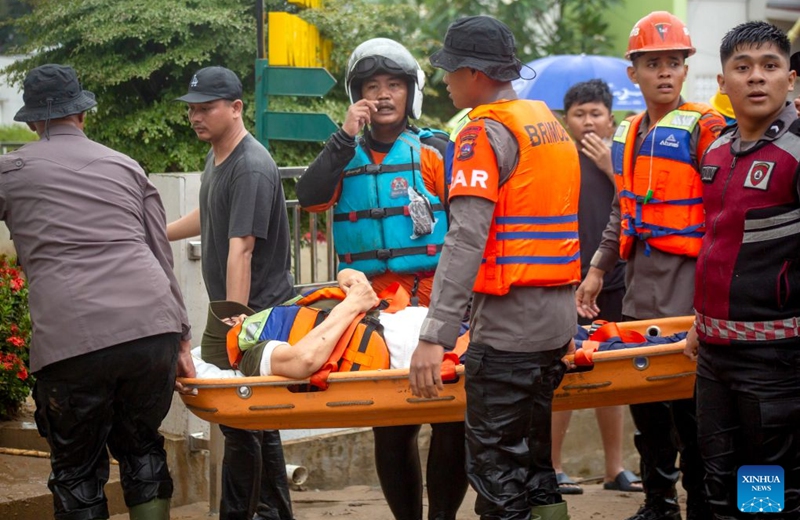 Rescuers evacuate a resident from floodwaters after heavy rain hit Padang in West Sumatra Province, Indonesia, Oct. 10, 2026. (Photo by Andri Mardinsyah/Xinhua)