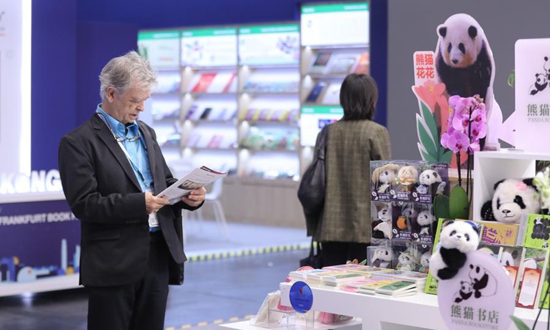 A reader is seen at the Chinese joint exhibition booth of the Frankfurt Book Fair in Frankfurt, Germany, Oct. 7, 2026.  (Xinhua/Du Zheyu)