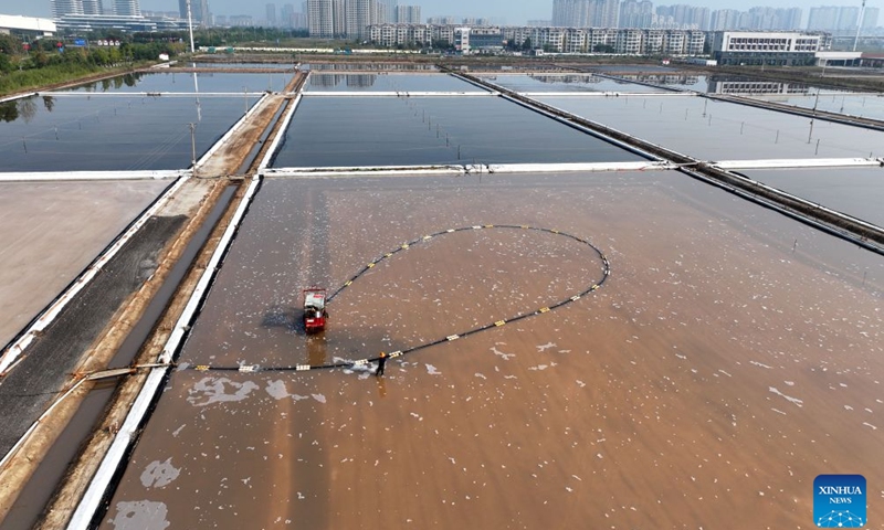 A drone photo taken on Oct. 11, 2026 shows workers operating in a salt field in Lianyungang City, east China's Jiangsu Province. Autumn salt harvest is underway in coastal salt fields in Lianyungang. (Photo by Wang Chun/Xinhua)

