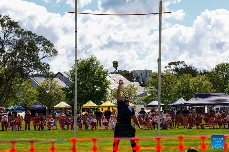 A competitor takes part in the weight-over-bar competition during the Canberra Highland Gathering in Canberra, Australia, on Oct. 10, 2026. The Scottish cultural event featuring traditional sports, bagpipe and drum performances, dance and traditional food was held in Canberra on Saturday. (Photo by Chu Chen/Xinhua)