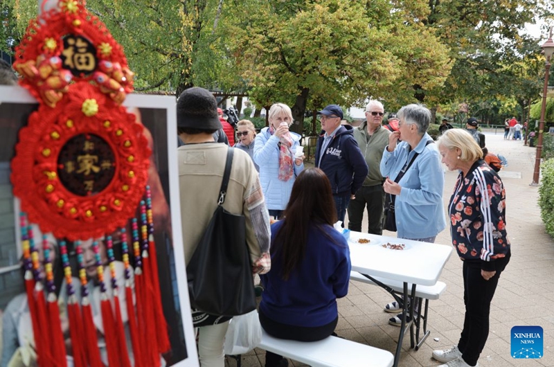 Visitors learn about Chinese food during the 2026 Siofok Fish Festival in Siofok, Hungary, Oct. 10, 2026. Sit on the southern shore of Lake Balaton, Hungary's largest lake, Siofok is one of the country's leading lakeside holiday destinations. The city's annual fish festival is a major autumn event, with its 13th edition taking place on Oct. 9-11, 2026. (Xinhua/Hu Zhixuan)