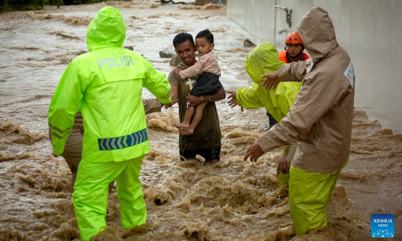 Rescuers evacuate residents from floodwaters after heavy rain hit Padang in West Sumatra Province, Indonesia, Oct. 10, 2026. (Photo by Andri Mardinsyah/Xinhua)
