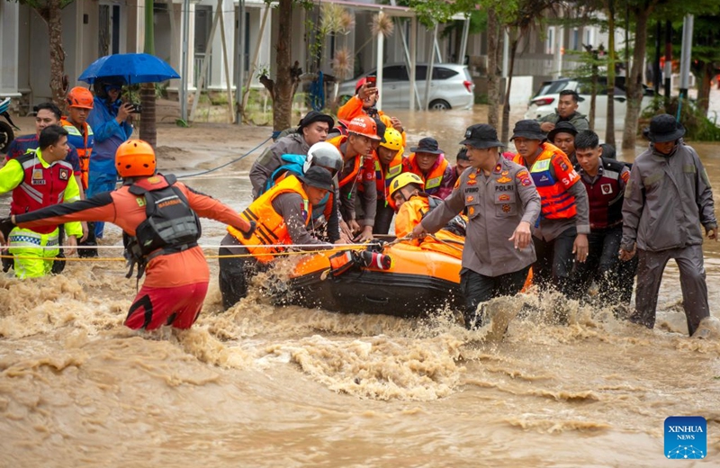 Rescuers are seen in floodwaters after heavy rain hit Padang in West Sumatra Province, Indonesia, Oct. 10, 2026. (Photo by Andri Mardinsyah/Xinhua)
