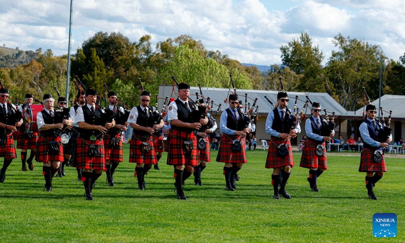 Members of a pipe band perform during the Canberra Highland Gathering in Canberra, Australia, on Oct. 10, 2026. The Scottish cultural event featuring traditional sports, bagpipe and drum performances, dance and traditional food was held in Canberra on Saturday. (Photo by Chu Chen/Xinhua)