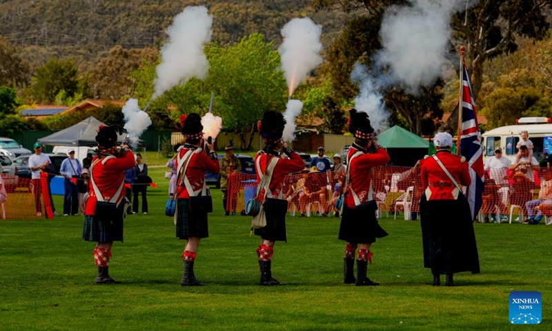 A ceremonial guard dressed in traditional Scottish attire performs a musket-firing display during the Canberra Highland Gathering in Canberra, Australia, on Oct. 10, 2026. The Scottish cultural event featuring traditional sports, bagpipe and drum performances, dance and traditional food was held in Canberra on Saturday. (Photo by Chu Chen/Xinhua)