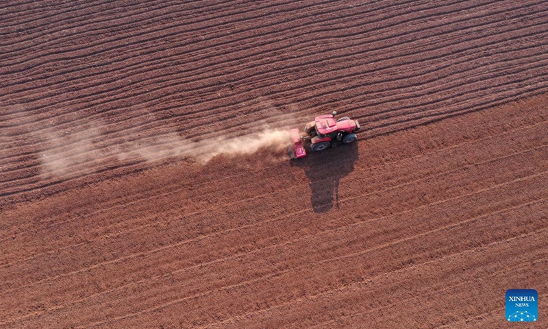 An aerial drone photo taken on Oct. 10, 2026 shows farm machinery working in the fields ahead of wheat sowing at Shiyuan Village in Qinyang City, central China's Henan Province. As autumn sets in, farmers across China make the most of the farming season to work to ensure stable grain production. (Photo by Yang Fan/Xinhua)