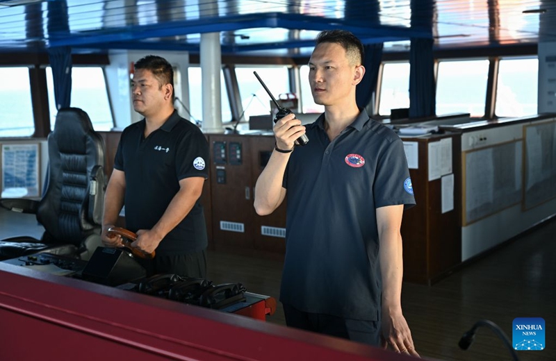 Captain Zhao Xin (R) holds a handheld radio as third officer Song Yunduo steers the research vessel Deep Sea No. 1 into position for the launch of the manned deep-sea submersible Jiaolong in the western Pacific Ocean, on Oct. 10, 2026. China's research vessel Deep Sea No. 1, carrying manned deep-sea submersible Jiaolong, arrived at East Caroline Basin in the western Pacific Ocean on Saturday for deep-sea scientific research.
This marks the 466th dive of Jiaolong, with a planned diving depth of about 4,500 meters. Photo: Xinhua