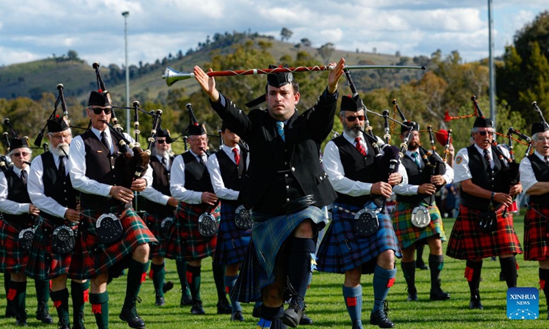 Members of a pipe band perform during the Canberra Highland Gathering in Canberra, Australia, on Oct. 10, 2026. The Scottish cultural event featuring traditional sports, bagpipe and drum performances, dance and traditional food was held in Canberra on Saturday. (Photo by Chu Chen/Xinhua)