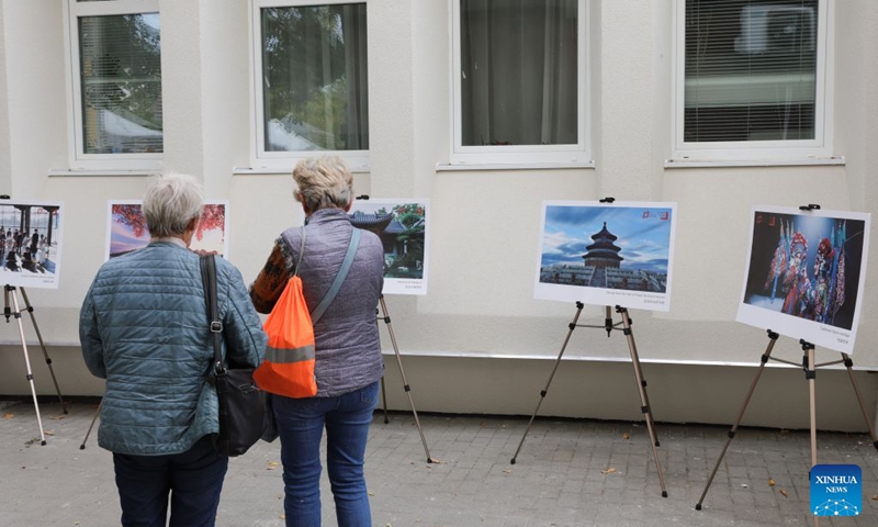 People check a photo exhibition about China during the 2026 Siofok Fish Festival in Siofok, Hungary, Oct. 10, 2026. Sit on the southern shore of Lake Balaton, Hungary's largest lake, Siofok is one of the country's leading lakeside holiday destinations. The city's annual fish festival is a major autumn event, with its 13th edition taking place on Oct. 9-11, 2026. (Xinhua/Hu Zhixuan)
