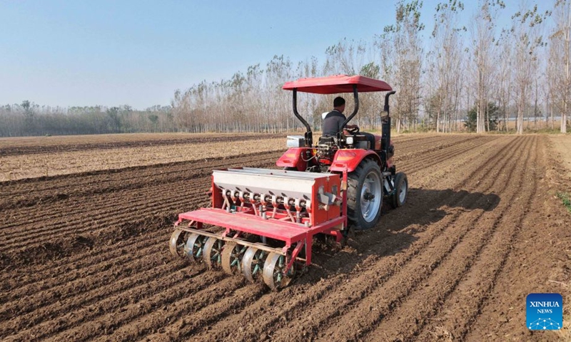 A farmer sows wheat with machinery in the fields at Jiazhai Town in Liaocheng City, east China's Shandong Province, Oct. 10, 2026. As autumn sets in, farmers across China make the most of the farming season to work to ensure stable grain production. (Photo by Zhao Yuguo/Xinhua)