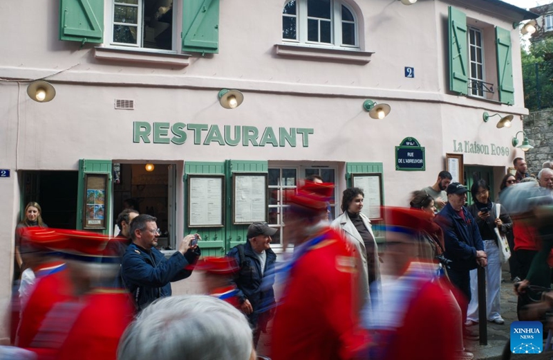 People watch a parade during the Montmartre Grape Harvest Festival in Paris, France, Oct. 10, 2026. The 93rd edition of the Montmartre Grape Harvest Festival runs from Oct. 7 to 11, featuring a grand parade, musical performances and other festivities. (Xinhua/Wu Huiwo)