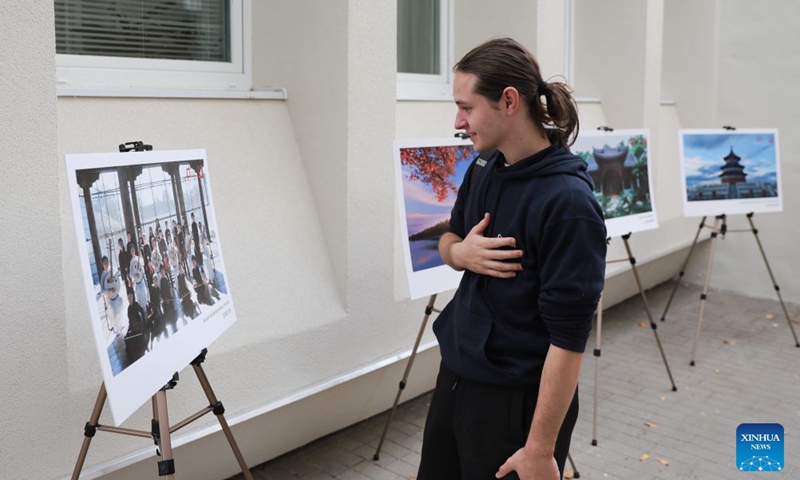A man checks a photo exhibition about China during the 2026 Siofok Fish Festival in Siofok, Hungary, Oct. 10, 2026. Sit on the southern shore of Lake Balaton, Hungary's largest lake, Siofok is one of the country's leading lakeside holiday destinations. The city's annual fish festival is a major autumn event, with its 13th edition taking place on Oct. 9-11, 2026. (Xinhua/Hu Zhixuan)