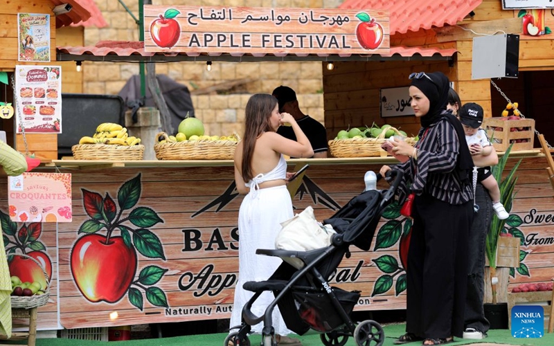 People visit an apple festival in the village of Baskinta, Lebanon, Oct. 10, 2026. (Xinhua/Bilal Jawich)