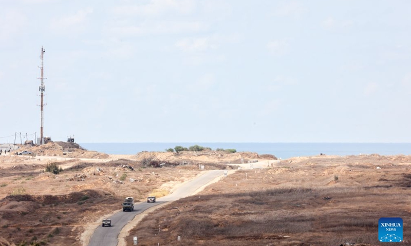 This photo taken from an area near Israel's southern border on Oct. 6, 2026 shows Israeli military vehicles moving inside the Gaza Strip. (Photo by Gil Cohen Magen/Xinhua)

