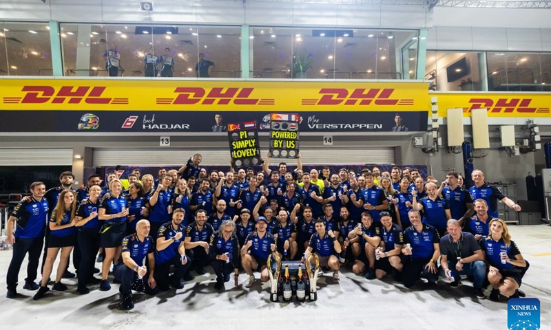 Red Bull's Max Verstappen (bottom C) of the Netherlands celebrates his win with team members after the Formula One Singapore Grand Prix at the Marina Bay Street Circuit in Singapore, on Oct. 11, 2026. (Photo by Li Chao/Xinhua)
